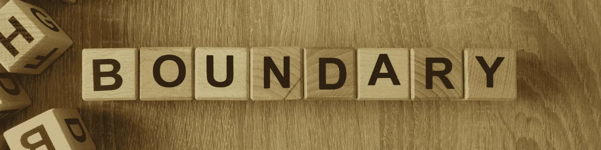 10 Tips for Setting Boundaries in Alcohol Recovery A image with the word "boundary" spelled out in scrabble tiles