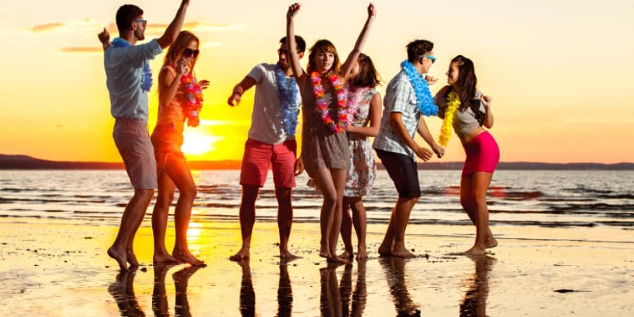 Alcohol-Free Parties Shine in Miami Beach 7 friends partying at a beach