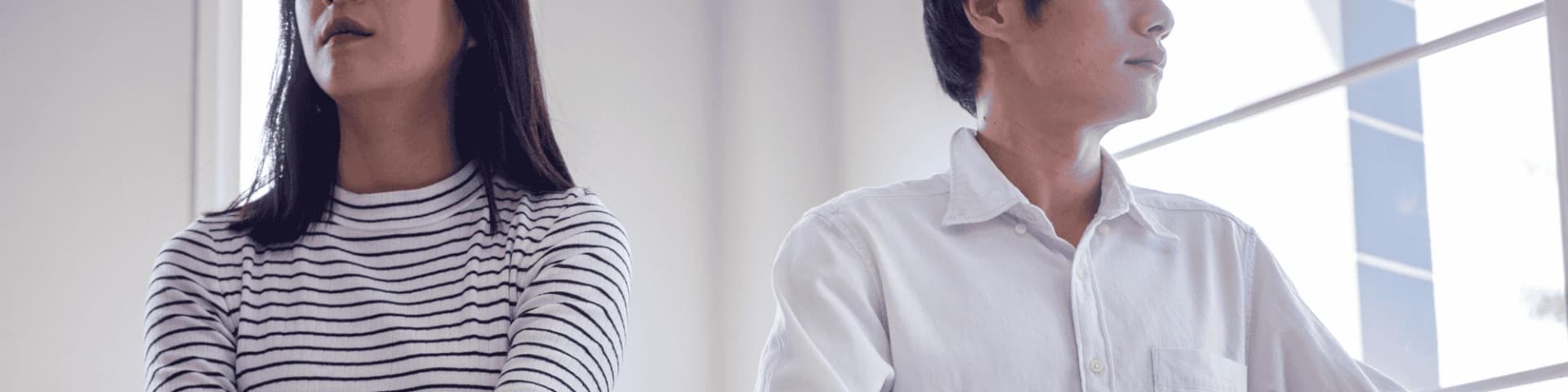 Consequences of Alcoholism on the Family A couple facing away from each other after fighting because one is an alcoholic