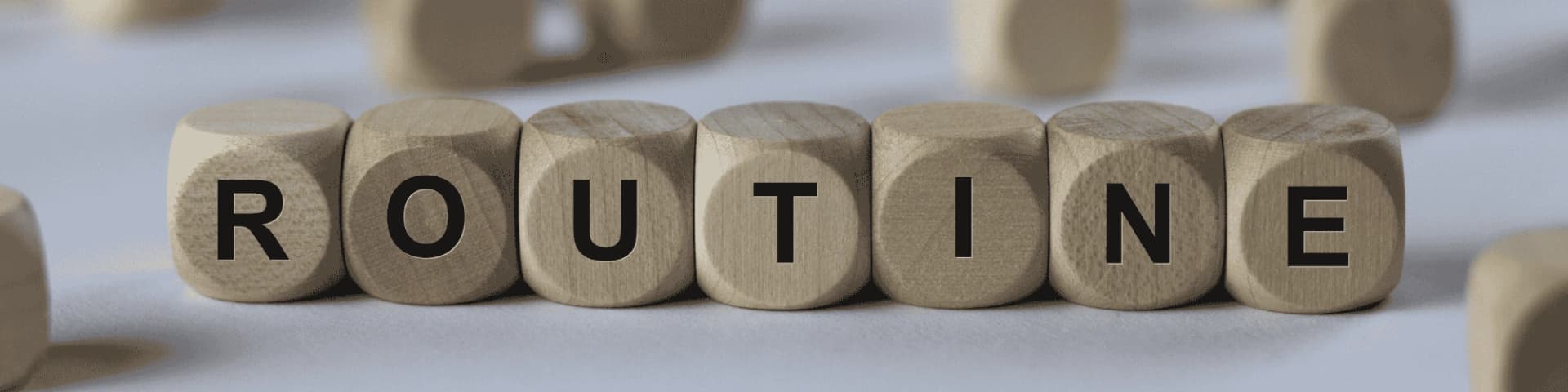 Creating a Sober Routine with NY AA Meetings Nearby wooden blocks that spell "routine"