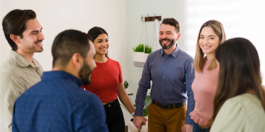 Discover the Benefits of Morning AA Meetings Near Me Friends in a circle happy that they got to attend a morning AA meeting near me