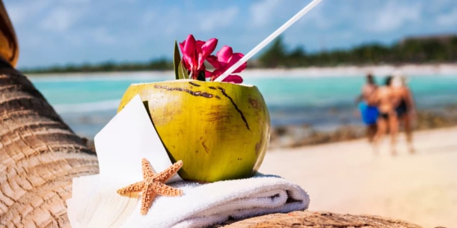 Drinking at The Beach A coconut drink at the beach, a healthier alternative to alcohol