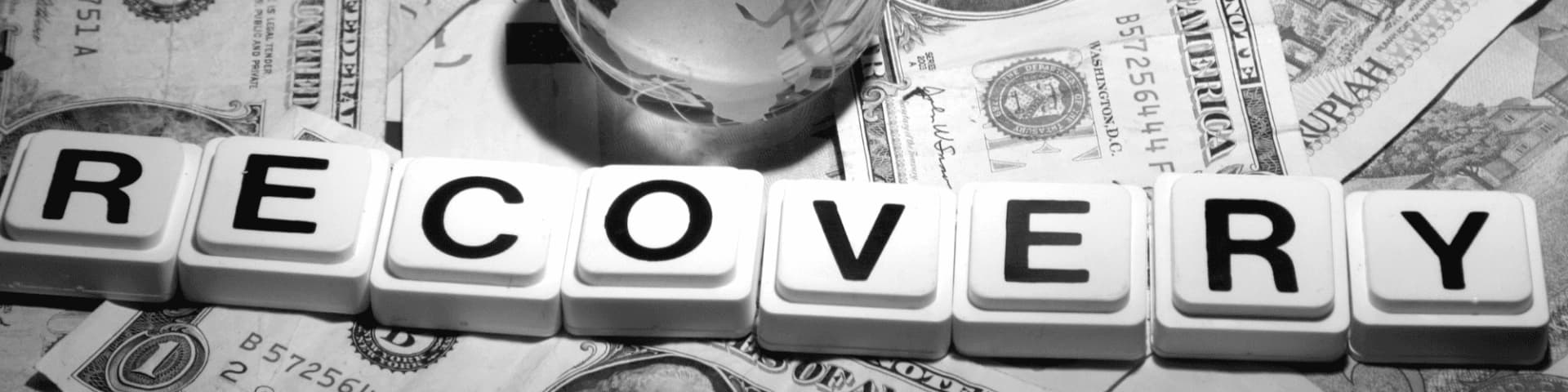 Financial Recovery Tips After Alcohol Addiction A photo with the word "recovery" spelled out on top of bills, suggesting financial recovery