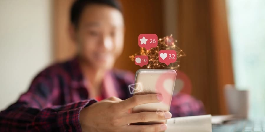 Here’s How the Media Impacts Alcohol Addiction and Recovery A person scrolling through his phone