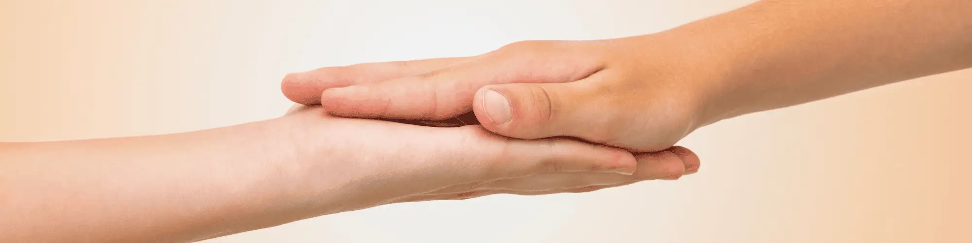 How the AA Hotline Contact Connects You with AA Meetings two hands, showing human connection by holding one another