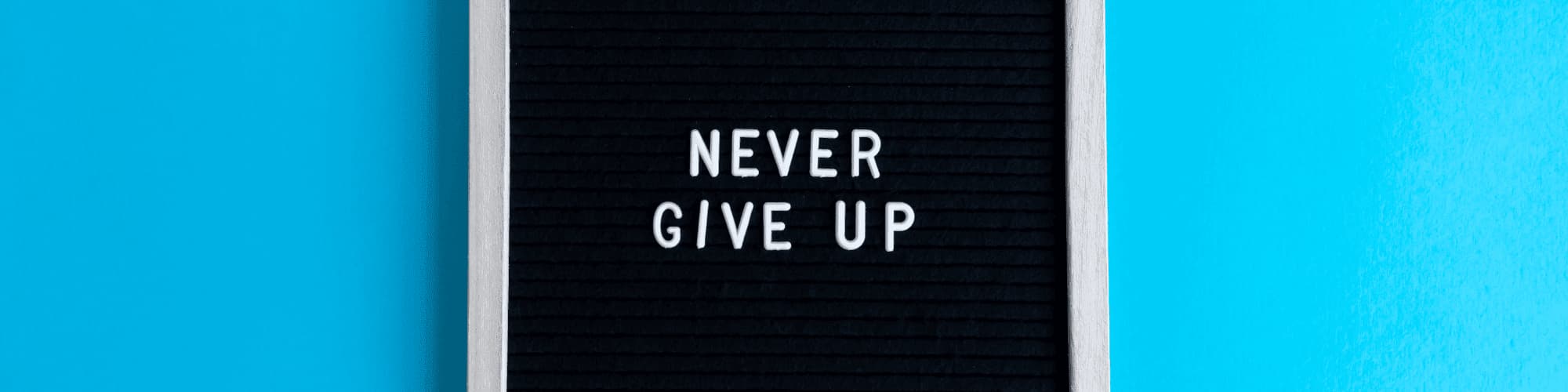 Stay Motivated in Recovery: Find NY Intergroup AA Meetings A sign that says "never give up"