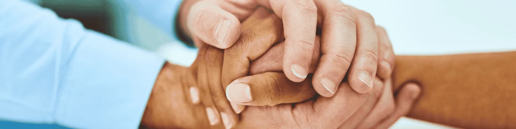 Supporting Loved Ones: How to Be There for Someone in Recovery hands holding one another