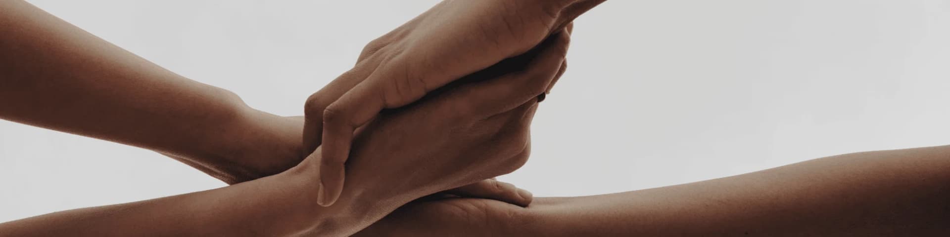 The Power of Shared Experiences in Alcohol Recovery holding hands, representing shared experiences