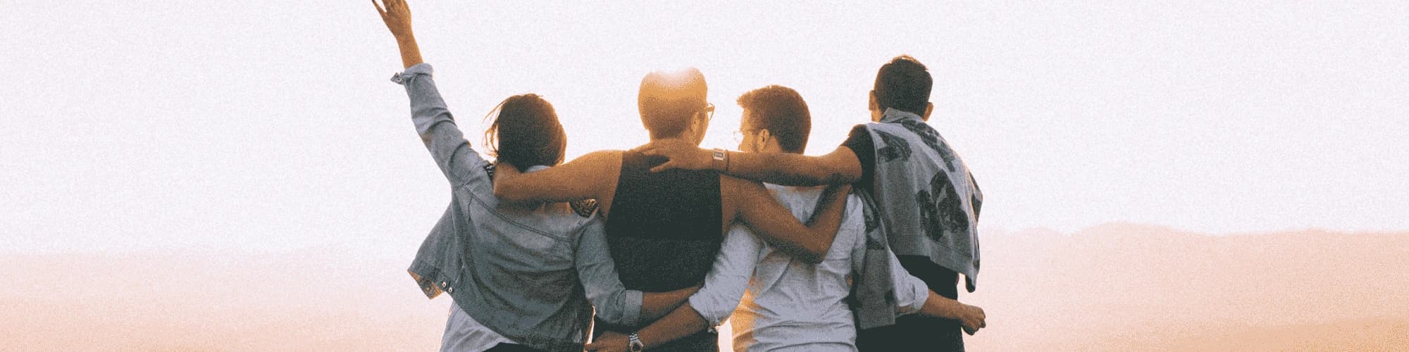 The Role of Peer Support in Staying Sober Long-Term A group of friends watching the sunset