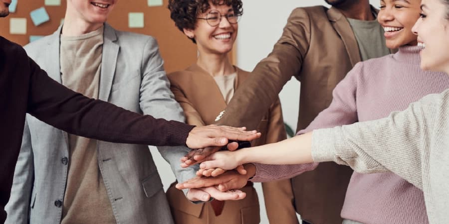 Why Going to AA Meetings Can Transform Your Journey A group of people in agreement and joining together