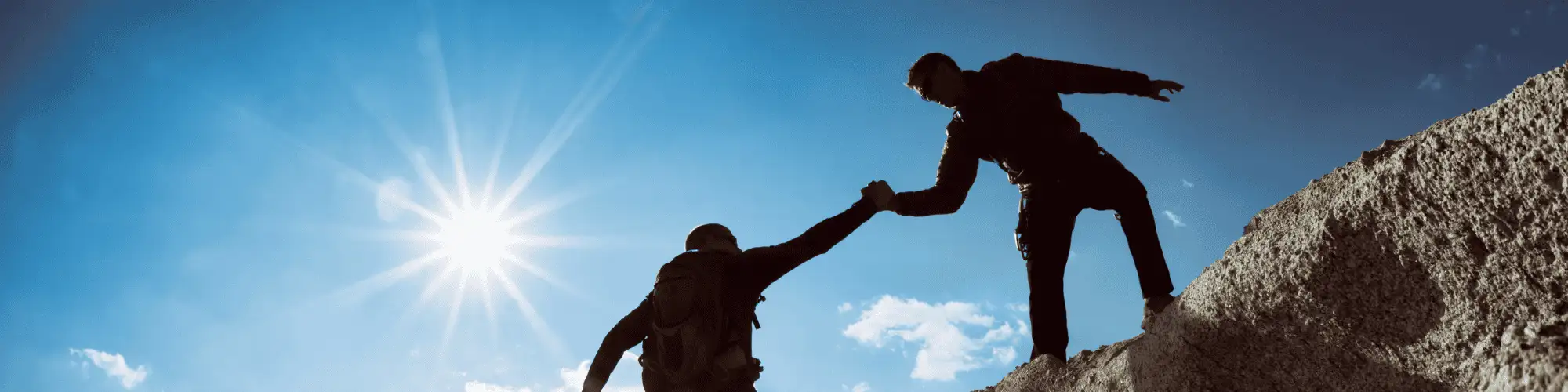 You’re Not Alone with Alcoholics Anonymous Meetings Seattle one man helping another on a difficult climb