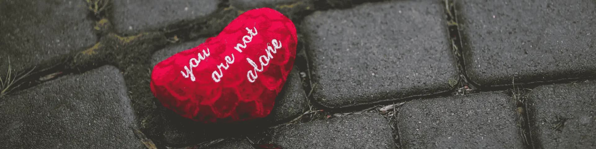 You Are Not Alone: How Local AA/NA Meetings Bring Hope a heart-shaped object that says "you are not alone"